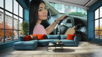 Asian girl smiling  relaxing sitting and prepare drive safety Wall mural