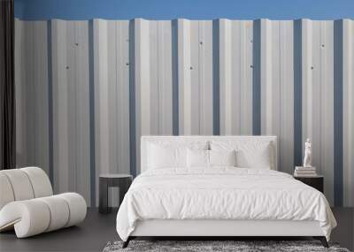 White corrugated metal fence with blue sky Wall mural