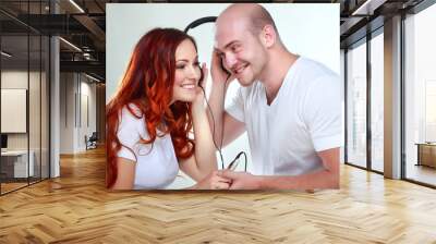 A young man and girl listen music Wall mural