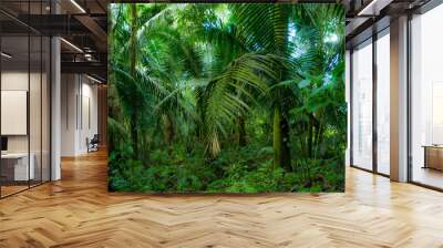 A lush background of a tropical forest, a banner of nature with lush green colors Wall mural