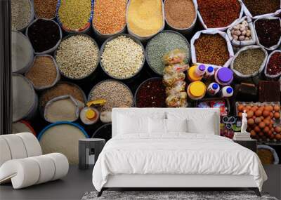 Colourful background of many different types of seeds, rice, corn, eggs and candy Wall mural