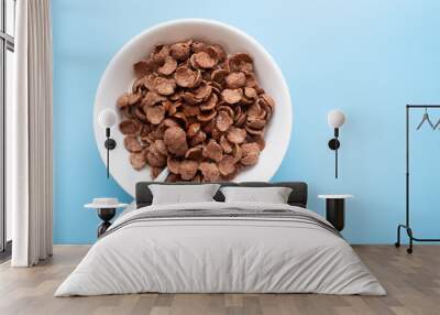 Bowl of cereal chocolate flavor and milk breakfast with silver spoon Wall mural