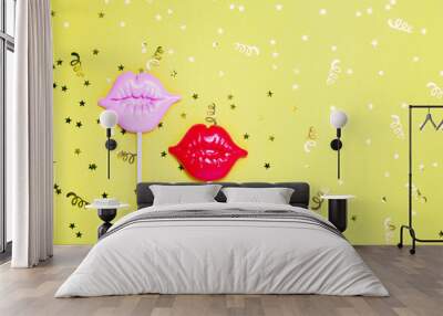 Red and pink lips for fun on yellow festive background. Wall mural