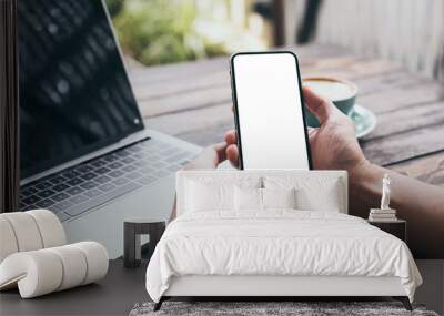 cell phone mockup image blank white screen.man hand holding texting using mobile on desk at coffee shop.background empty space for advertise.work people contact marketing business,technology Wall mural