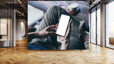 cell phone mockup image blank white screen.woman hand holding texting using mobile on desk at coffee shop.background empty space for advertise.work people contact marketing business,technology Wall mural