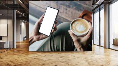 cell phone mockup image blank white screen.woman hand holding texting using mobile on desk at coffee shop.background empty space for advertise.work people contact marketing business,technology Wall mural