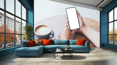 cell phone mockup image blank white screen.woman hand holding texting using mobile on desk at coffee shop.background empty space for advertise.work people contact marketing business,technology Wall mural