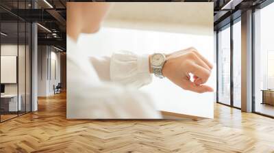 fashionable wearing stylish looking at luxury watch on hand check the time at workplace.concept for managing time organization working,punctuality,appointment Wall mural