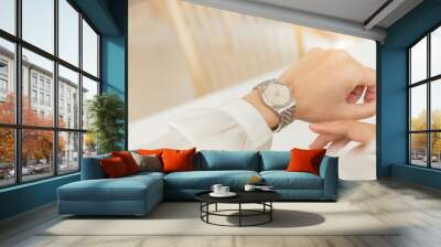 fashionable wearing stylish looking at luxury watch on hand check the time at workplace.concept for managing time organization working,punctuality,appointment Wall mural