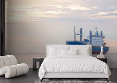 logistics and transportation concept.cargo ship import export commerce sail boat at sea at twilight sky Wall mural