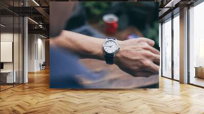 looking at luxury watch on hand check the time at workplace.concept for managing time organization working,punctuality,appointment.fashionable wearing stylish Wall mural