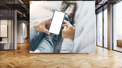 Mockup image blank white screen cell phone.man hand holding texting using mobile on safa at home office.background empty space for advertise text.people contact marketing business,technology  Wall mural