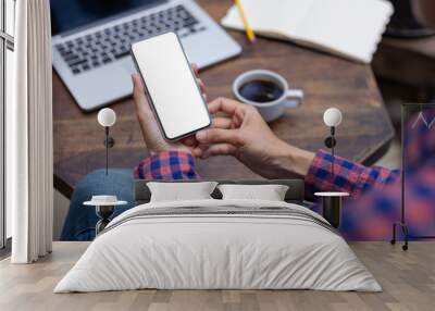 Mockup image blank white screen cell phone.woman hand holding texting using mobile on desk at coffee shop.background empty space for advertise text.people contact marketing business,technology  Wall mural