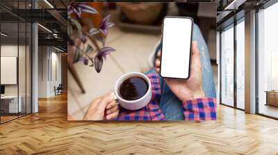 Mockup image blank white screen cell phone.woman hand holding texting using mobile on desk at coffee shop.background empty space for advertise text.people contact marketing business,technology  Wall mural