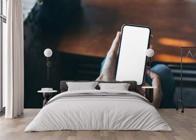 Mockup image blank white screen cell phone.woman hand holding texting using mobile on desk at coffee shop.background empty space for advertise text.people contact marketing business,technology Wall mural