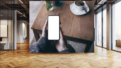 Mockup image blank white screen cell phone.woman hand holding texting using mobile on desk at coffee shop.background empty space for advertise text.people contact marketing business,technology Wall mural