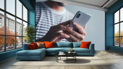 using cell phone.hand holding texting message on screen mobile chatting friend ,search internet information sitting in office.technology device contact communication connecting people concept Wall mural