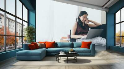 using computer.hand typing keyboard laptop online chatting search form internet while working sitting on sofa.concept for work from home.technology device contact communication business people Wall mural