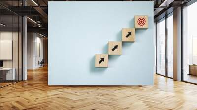 Top view wooden blocks set to step with icon arrow to target. Concept for growth business and targeting. Wall mural