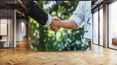 .World Environment Day business partner colleagues shaking hands during a meeting working together in sustainability. Save Earth, World Environment Day concept, Earth Day. Wall mural