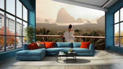 woman with the white dress sit and see the mountain in early morning at the sametnangshe island view Wall mural