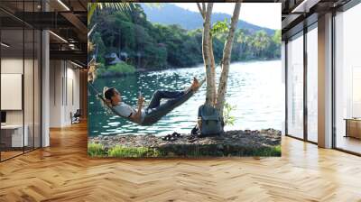 Man sleeping in a hammock at the beach Wall mural