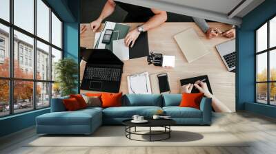 Co-working business people at one table a top view. Work for laptops on the table. Startup development Wall mural