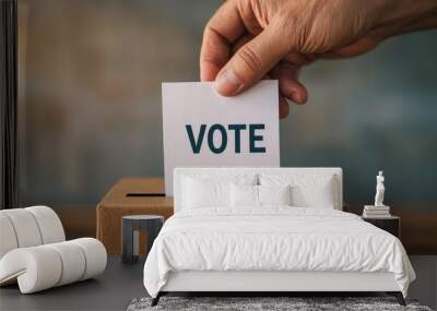 A hand placing a ballot into a voting box, symbolizing democracy and civic duty during elections. Wall mural