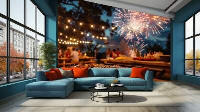 Festive outdoor party with barbecue, fairy lights, and fireworks in the evening sky, creating a joyful celebration atmosphere. Wall mural