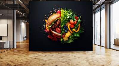 Close up of a burger and a salad on a black background. The burger is on the left side of the image and the salad is on the right. The burger is covered in meat and cheese Wall mural