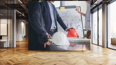 contractor and engineer with blueprints discuss at a modern construction site, Engineers in mechanical factory reading instructions Wall mural