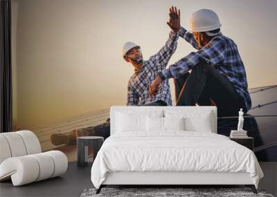 Electrical, instrument technician celebrate their work day done, maintenance electric system by shake hands at solar panel field  Wall mural