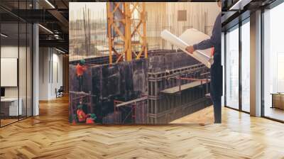 Smart civil architect engineer inspecting and working outdoors structure building site with blueprints. engineering and architecture concept. Wall mural