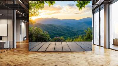 A serene sunset view over lush mountains, framed by vibrant foliage, perfect for nature lovers and tranquil escapes. Wall mural