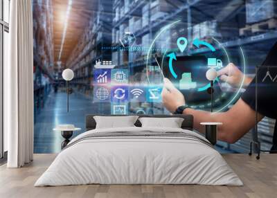 Business Logistics technology concept.Man hands using tablet on blurred warehouse as background Wall mural