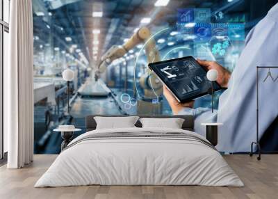 Smart industry control concept.Hands holding tablet on blurred automation machine as background Wall mural