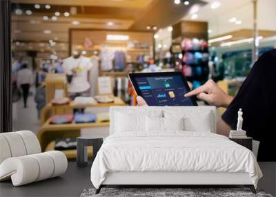 Smart store management systems concept.Manager using digital tablet on blurred store as background Wall mural