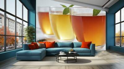 Three glass cups tea white surface are filled A row of four Wall mural