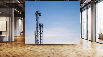 Two Telecom cell phone or telecommunication masts with blue sky backdrop, telecom tower infrastructure for background uses Wall mural