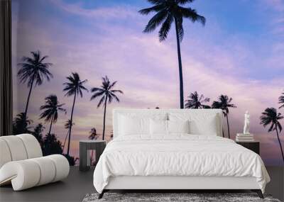 Beautiful sunset or sunrise with silhouette palm trees on tropical island Beautiful light of nature scenery background. Wall mural