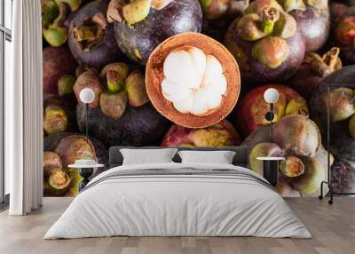 Mangosteen and cross section showing the thick purple skin and w Wall mural