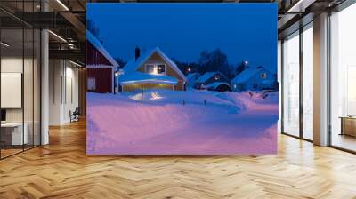 lights in houses in the evening in winter with snow Wall mural