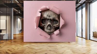 Skull looking through pink ripped paper. Minimal Halloween concept. Wall mural