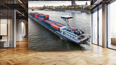 A large barge loaded with shipping containers floating on the river Rhine in Cologne. Wall mural