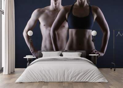 strong man and a woman posing on a black background Wall mural