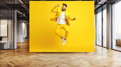 Full length body size view of attractive cheerful guy dancing having fun isolated over bright yellow color background Wall mural