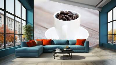 Coffee beans in coffee cup Wall mural