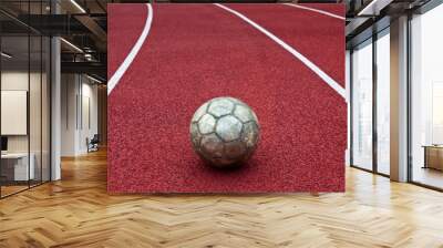 Soccer ball on all-weather running track Wall mural