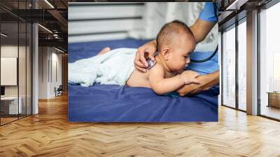 Asian Doctor examining little baby with stethoscope in clinic. Baby health concept Wall mural