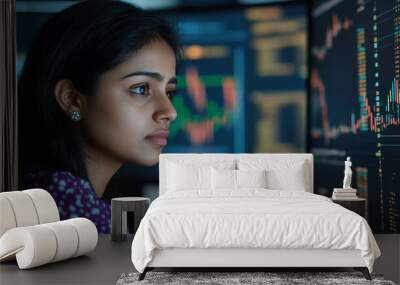 Indian businesswoman using a computer to analyze stock market trends modern portrait financial graphs background Wall mural